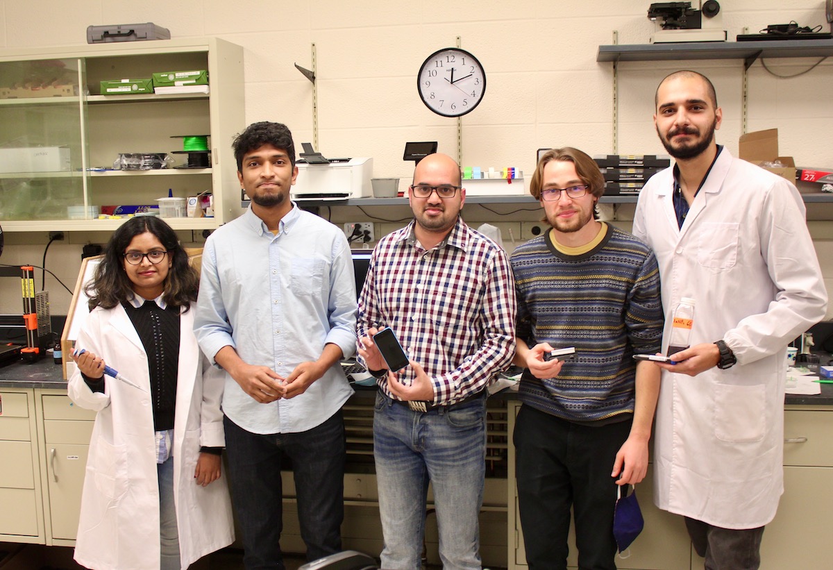 Aashish Priye, middle, stands in his University of Cincinnati laboratory with his graduate and undergraduate students. 2020 